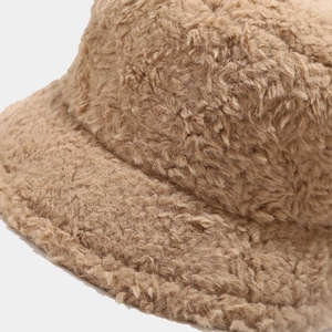Thick light brown sherpa bucket hat for winter featuring a soft fleece texture and warm design