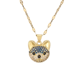 Detailed view of a gold-plated dog pendant necklace with sparkling colorful zircon inlay