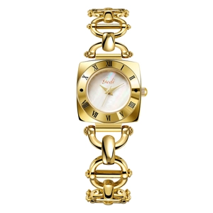 Detail shot of vintage square gold watch with mother of pearl dial and roman numerals