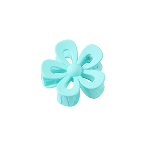 Macro shot of mint blue flower hair claw clip with matte acrylic finish and petal texture