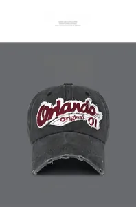 Close-up of distressed baseball cap with Orlando embroidery and frayed brim detail