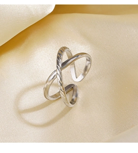 Detail showing X-shaped crisscross ring with polished and twisted rope textures on silk