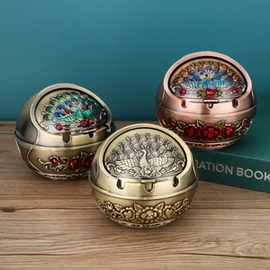 Detailed peacock relief on spherical metal ashtrays with decorative flip lids