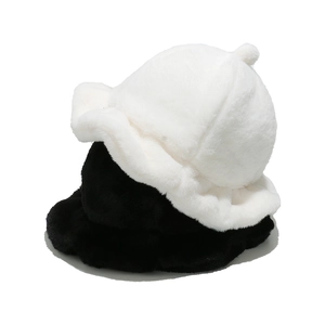 Close-up of soft plush bucket hats in black and white with ruffled edges for winter