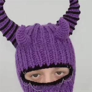 Detail of purple knitted balaclava with devil horns and silver chain for Halloween