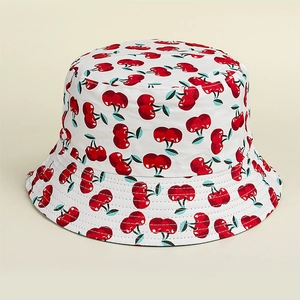 Close-up of white bucket hat with red cherry print and detailed parallel brim stitching