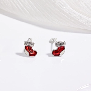 Macro shot of festive red enamel Christmas stocking stud earrings with small rhinestones