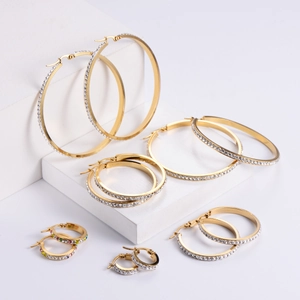 Set of gold stainless steel hoop earrings in various sizes with cubic zirconia stones