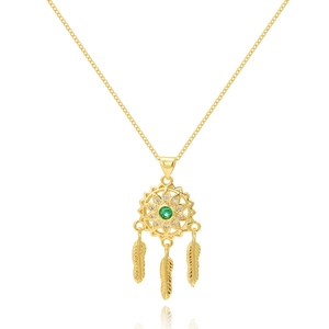 Macro detail of golden dreamcatcher necklace with emerald green stone and feather charms