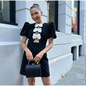 Vintage black polka dot mini dress with sweet bow details and puffy sleeves for women