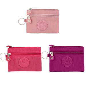 Nylon mini coin purse detail showing multi-layer zippers and metal key ring attachments