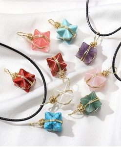 Macro detail of handmade wire-wrapped crystal star pendants with colorful natural stones