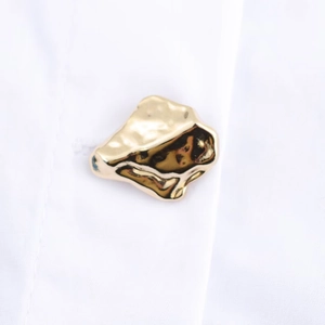 Minimalist white lapel shirt featuring unique gold irregular metal button detail