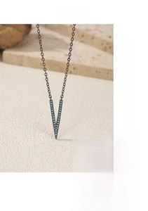 Detailed view of S925 silver V-shaped necklace with blue turquoise beads on stone