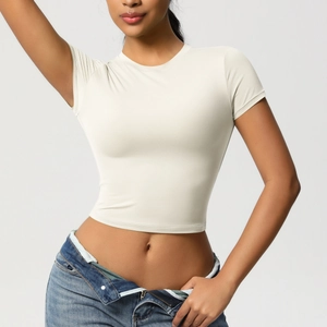 Close-up of cream white slim fit crop top showing elastic fabric texture and crew neck detail