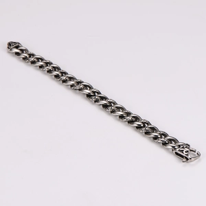 Macro view of vintage stainless steel Cuban bracelet with tribal leopard carving clasp