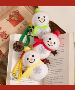 Three plush snowman keychains in red, yellow and green with embroidered snowflakes