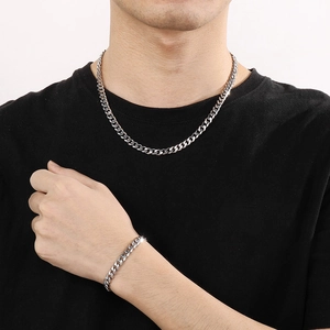 Men's silver stainless steel Cuban link chain necklace and bracelet set on model