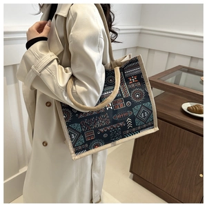Ethnic pattern cotton linen tote bag styled with cream trench coat in minimalist room