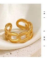 Detail of 18K gold plated chain ring with hammered texture on white satin and stone tray