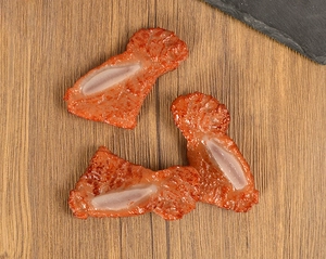 Detailed macro view of realistic faux lamb chop food models with fat and lean textures