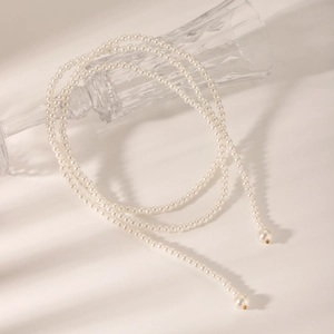 Detail of elegant multi-layered white pearl necklace with large drop pendants