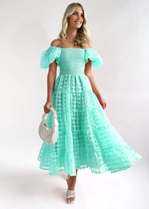 Close-up of mint green off-shoulder plaid dress with multi-layered tiered skirt