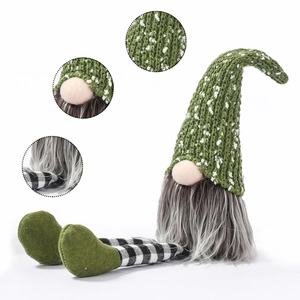 Detail of knitted forest green gnome hat and black and white plaid long legs for decor