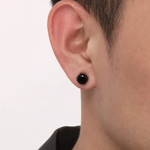 Close-up of black zircon magnetic stud earring worn on earlobe for non-pierced look