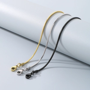 Detailed view of snake bone chain bracelets in gold, silver and black with lobster clasps