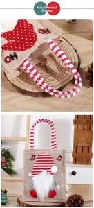 Detail of jute Christmas gift bag featuring a 3D gnome design and red striped handles