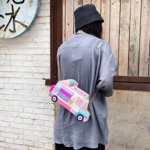 Detail of colorful laser ice cream truck crossbody bag with gold chain and plush ball