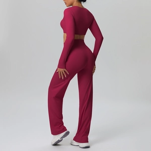 Rear view of slim fit long sleeve crop top and high waist wide leg yoga pants in dark red