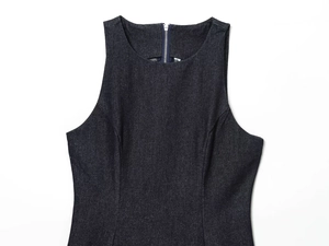 Detail view of dark denim dress featuring a round neckline and back metal zipper closure