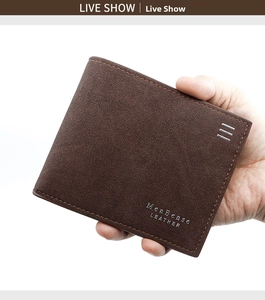 Detail of a brown matte leather men's wallet with metal logo and decorative hardware