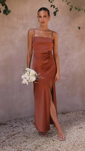 Detail of elegant rust red satin midi dress featuring a stylish side slit and thin straps
