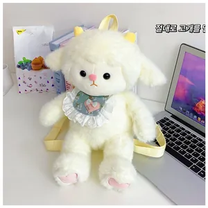 Close-up of fluffy white sheep plush backpack with blue floral bib and pink heart