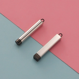 Close-up of cylindrical and rectangular stainless steel pendants with black caps