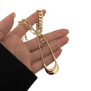 Hip hop gold plated chunky Cuban link necklace with oversized safety pin pendant detail