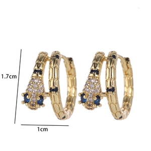 Detailed close-up of gold snake hoop earrings featuring white and blue zircon stones