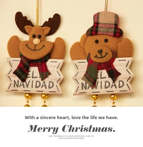 Detail of Christmas reindeer and bear plush ornaments with Navidad wooden plaques