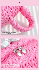 Close-up of pink quilted makeup bag showing padded handles and silver heart zippers