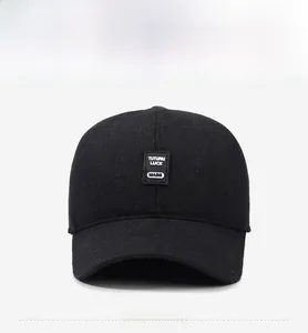 Close-up of winter wool baseball cap featuring a black leather logo patch with white text