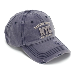 Detailed view of the vintage washed denim baseball cap with NYC embroidery and distressed holes