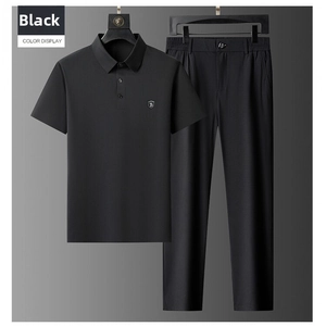Detail view of black men's ice silk polo shirt and trousers leisure set with small shield logo