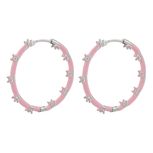 Macro detail of silver hoop earrings featuring pink enamel and set pink cubic zirconia stones