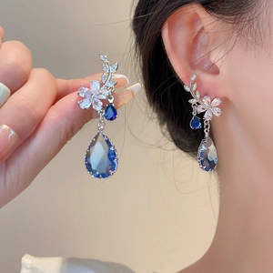 Elegant vintage silver earrings with floral zircon studs and blue teardrop gemstone pendants