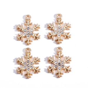Macro view of four golden snowflake jewelry pendants with sparkling zircon crystals