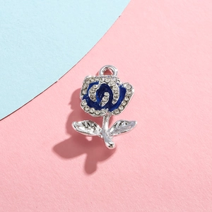 Detailed view of silver rose pendant with blue enamel and sparkling rhinestones