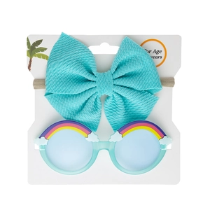 Close-up of mint green toddler sunglasses with rainbow decor and textured bow headband